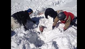 peopel digging out person trapped by avalanche